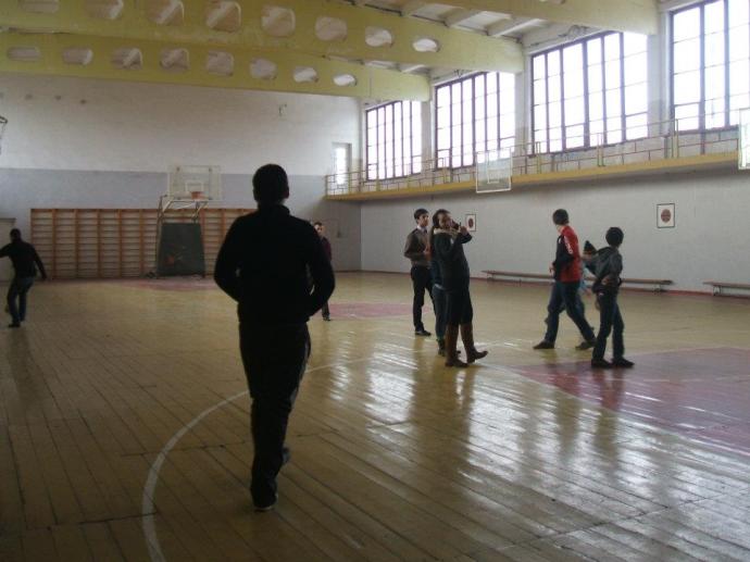 Playing basketball with friends at the sports school in Khoni